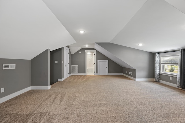 bonus room featuring light colored carpet and lofted ceiling