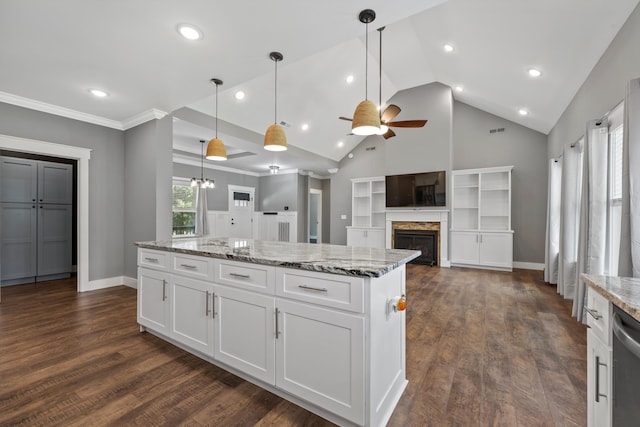 kitchen with white cabinets, decorative light fixtures, light stone countertops, and dark wood-type flooring