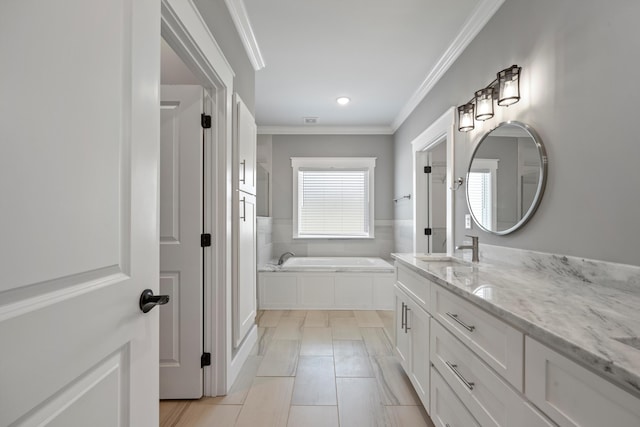 bathroom with vanity, a bathtub, and crown molding