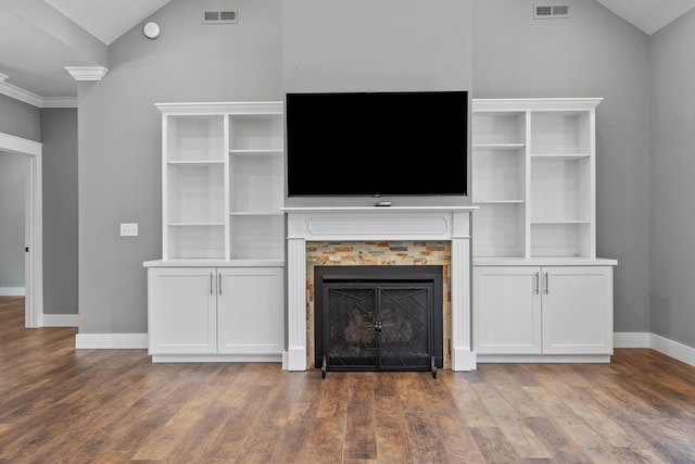 unfurnished living room featuring ornamental molding, dark hardwood / wood-style floors, and lofted ceiling