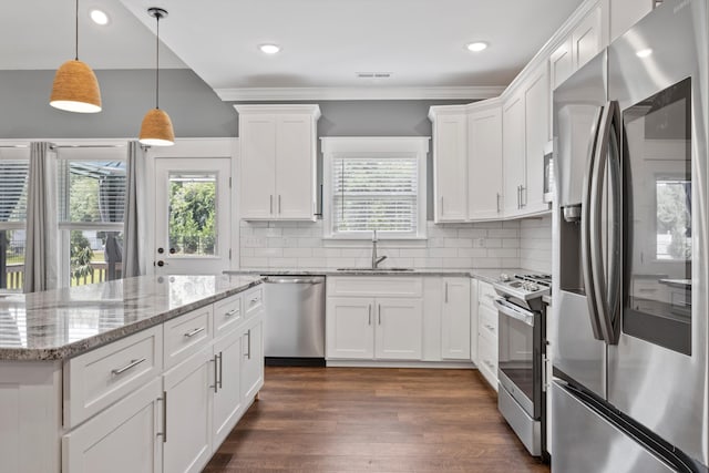 kitchen with white cabinetry, dark wood-type flooring, tasteful backsplash, pendant lighting, and appliances with stainless steel finishes