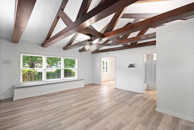 unfurnished living room with ceiling fan, light hardwood / wood-style flooring, and lofted ceiling with beams