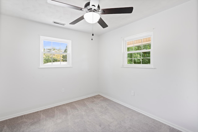 carpeted empty room featuring ceiling fan