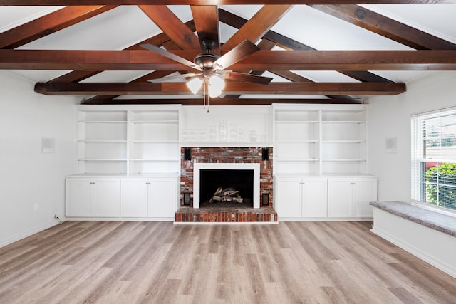 unfurnished living room with vaulted ceiling with beams, light hardwood / wood-style floors, and a fireplace