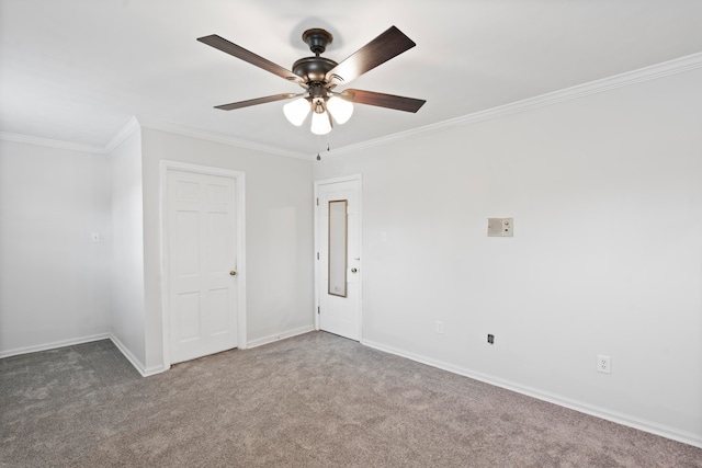 empty room featuring carpet flooring, ceiling fan, and crown molding