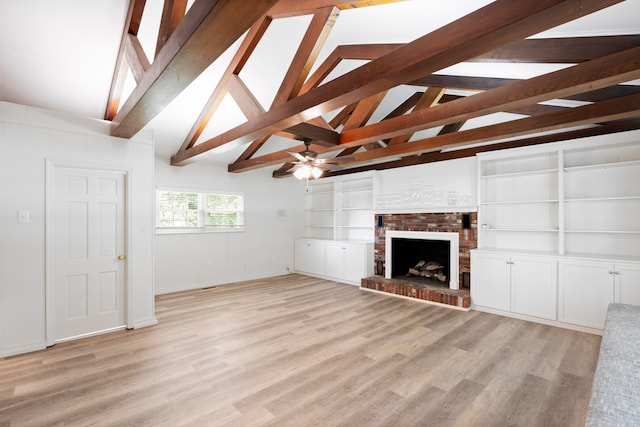 unfurnished living room featuring vaulted ceiling with beams, a fireplace, and light wood-type flooring