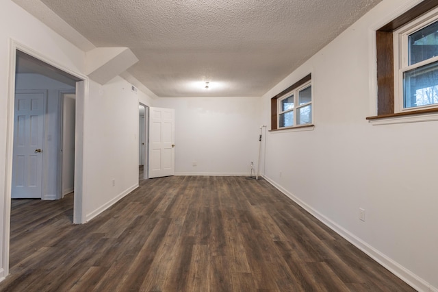 interior space featuring dark hardwood / wood-style flooring and a textured ceiling