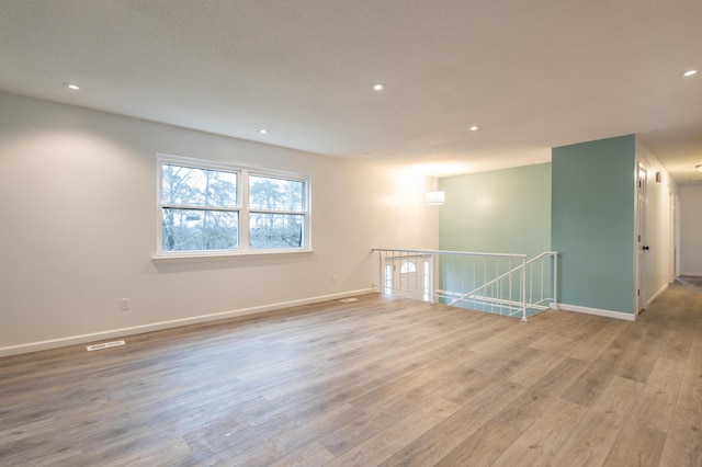 unfurnished room with light hardwood / wood-style floors