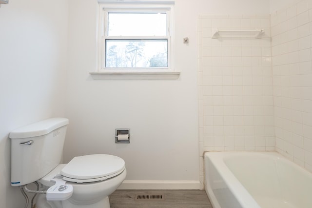 bathroom featuring toilet and wood-type flooring