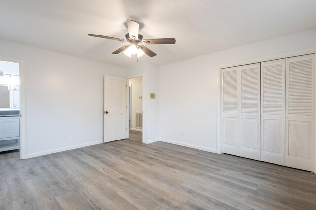 unfurnished living room featuring dark hardwood / wood-style floors, a textured ceiling, and a brick fireplace