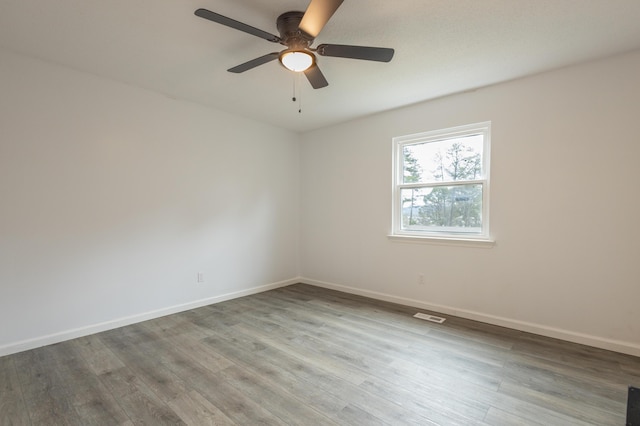 unfurnished room with hardwood / wood-style floors and ceiling fan