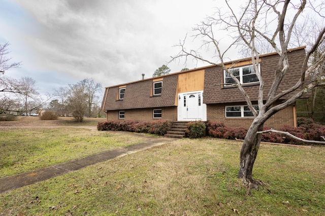 bi-level home with a front lawn