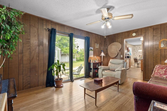 250 Rocky Ford Rd, Rossville, GA 30741 - living area with wood walls, ceiling fan, light wood-type flooring, and a textured ceiling