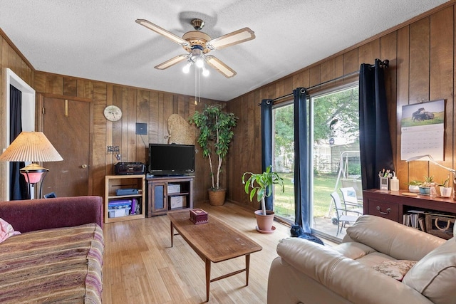 250 Rocky Ford Rd, Rossville, GA 30741 - living room with wooden walls, ceiling fan, light wood-style floors, and a textured ceiling