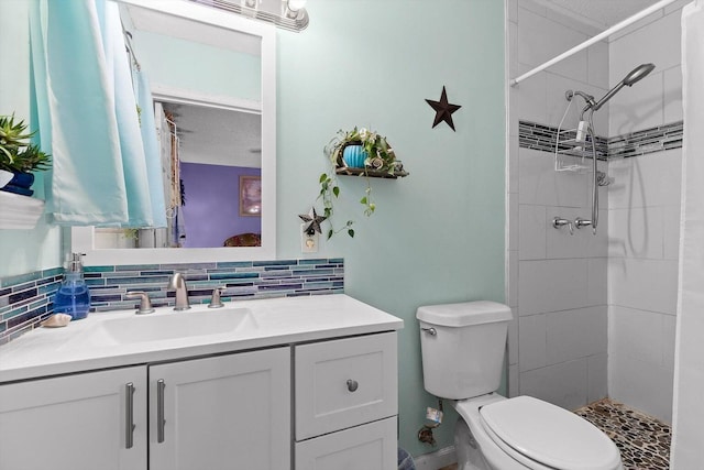 250 Rocky Ford Rd, Rossville, GA 30741 - full bath featuring toilet, vanity, a tile shower, and tasteful backsplash