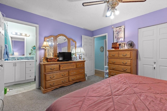 250 Rocky Ford Rd, Rossville, GA 30741 - carpeted bedroom with ensuite bathroom, a textured ceiling, a ceiling fan, a closet, and a sink