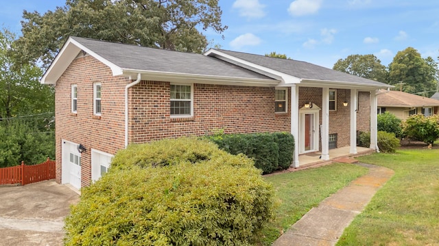 ranch-style house with a garage and a front lawn