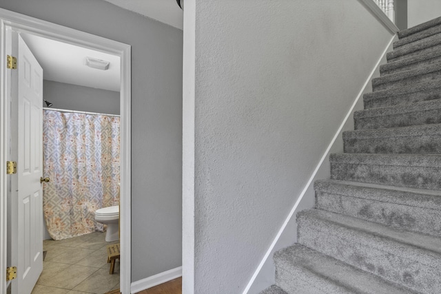 stairway featuring tile patterned flooring