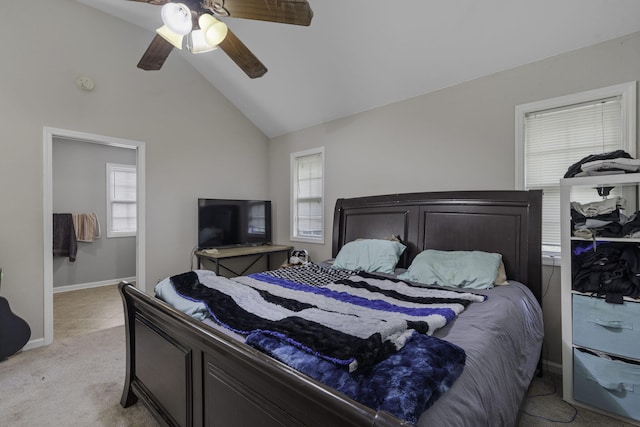 carpeted bedroom with ceiling fan and high vaulted ceiling