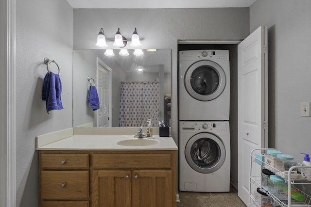 clothes washing area with stacked washer and dryer, sink, and light tile patterned floors