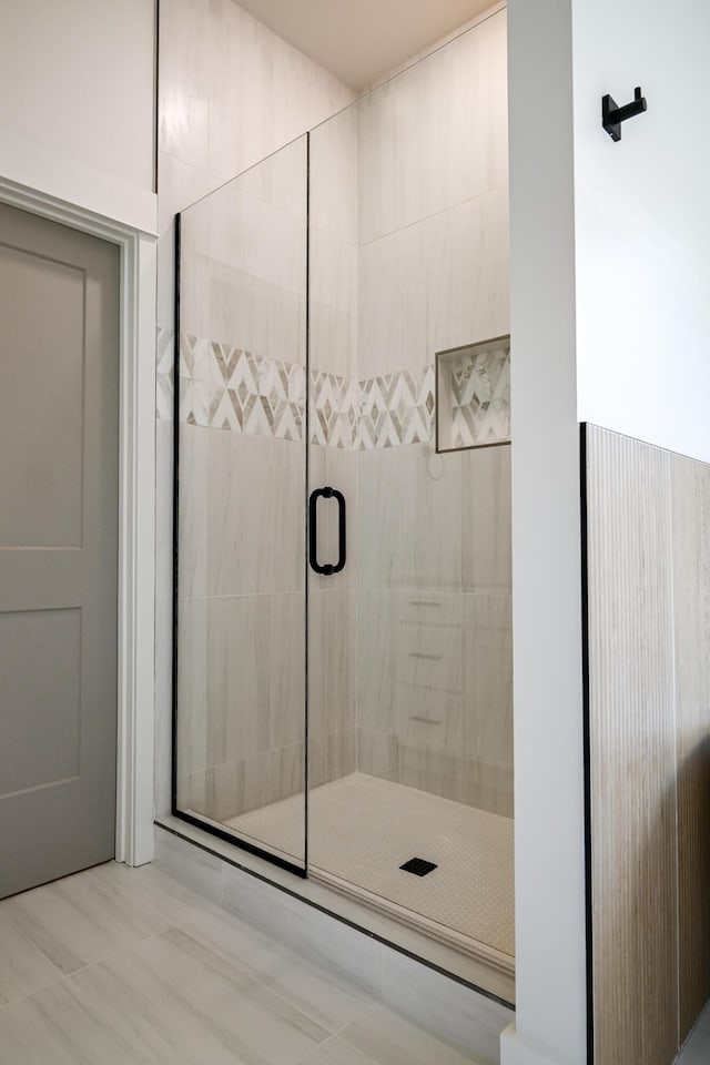 bathroom featuring a shower with shower door