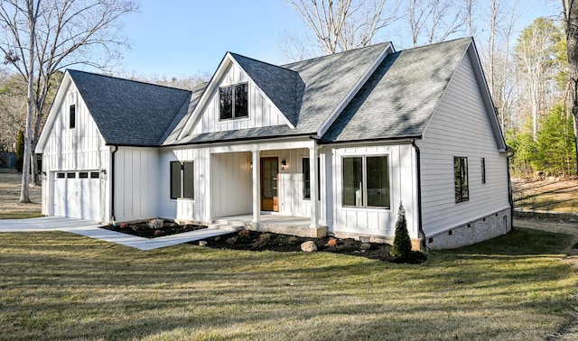 modern inspired farmhouse with a garage, a front lawn, and a porch