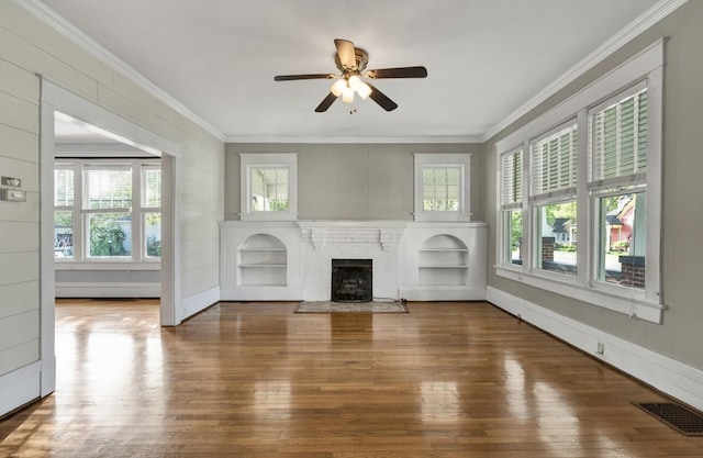 unfurnished living room with hardwood / wood-style flooring, visible vents, a ceiling fan, and crown molding