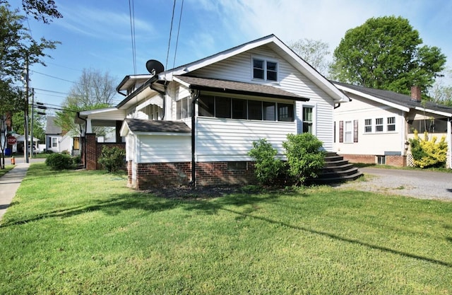 exterior space with a lawn and a shingled roof