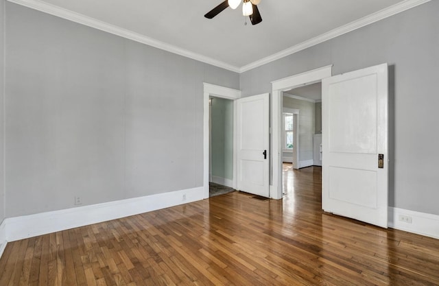 empty room with hardwood / wood-style flooring, baseboards, ceiling fan, and crown molding