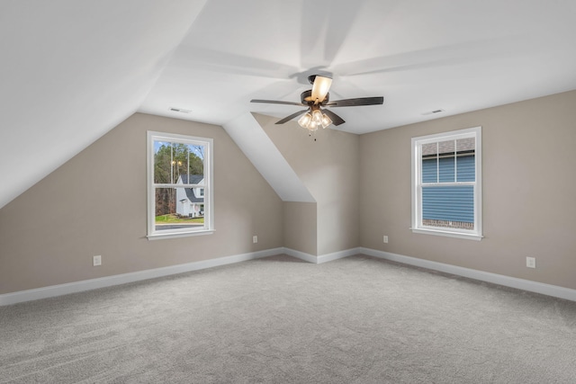 additional living space with light colored carpet, vaulted ceiling, and ceiling fan