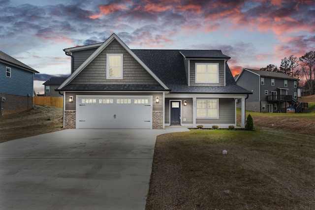 view of front of home with a yard and a garage