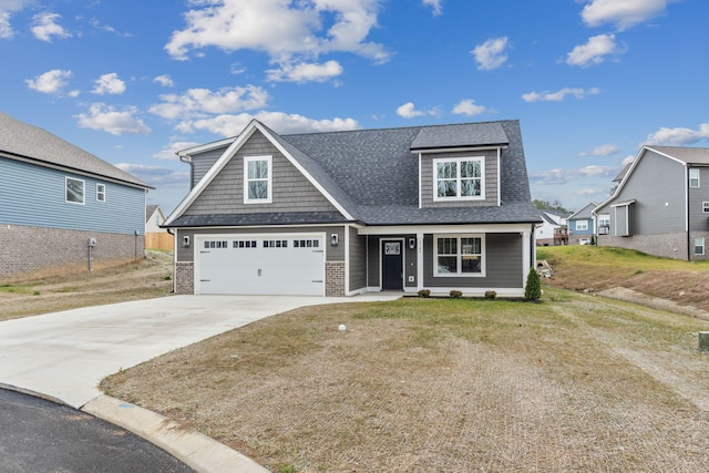 view of front of home with a front yard and a garage