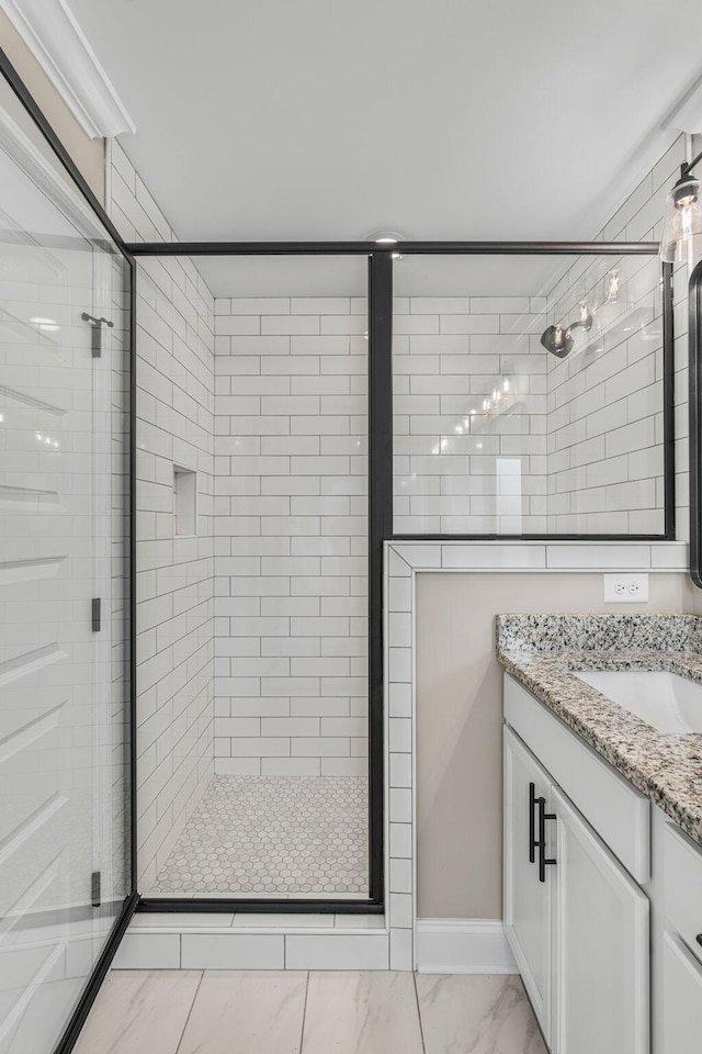 bathroom featuring vanity and a shower with shower door