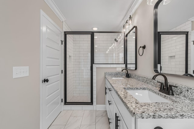 bathroom with vanity, a shower with door, and crown molding