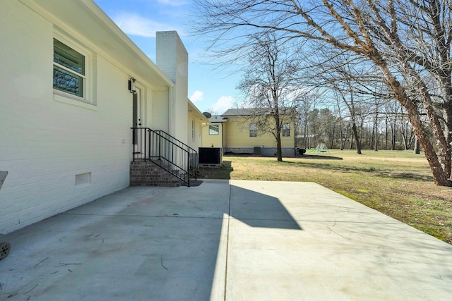 view of patio featuring central AC unit and a playground