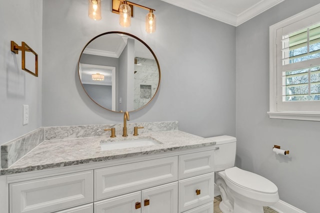 bathroom with toilet, baseboards, vanity, and crown molding
