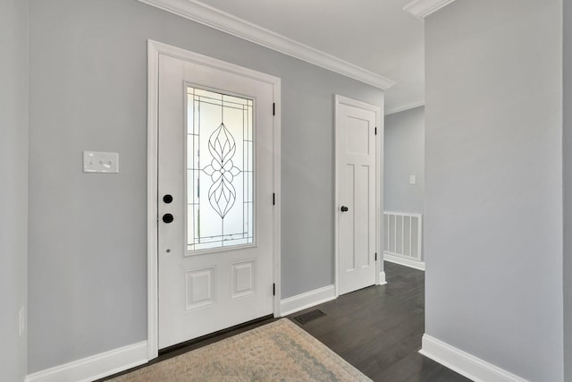 entrance foyer with baseboards, dark wood-style flooring, visible vents, and crown molding