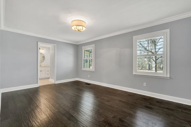 unfurnished bedroom with dark wood-type flooring, visible vents, crown molding, and baseboards