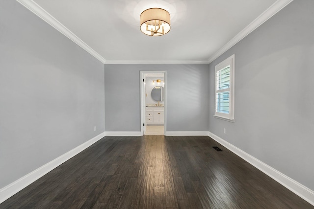 unfurnished bedroom with dark wood-style floors, visible vents, ensuite bathroom, ornamental molding, and baseboards