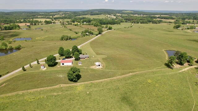 birds eye view of property featuring a rural view and a water view