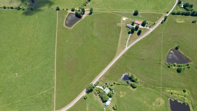 birds eye view of property with a water view and a rural view