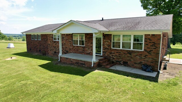 single story home with a front yard and a patio area