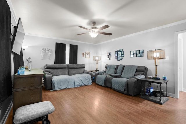 living room featuring ceiling fan, ornamental molding, and hardwood / wood-style floors