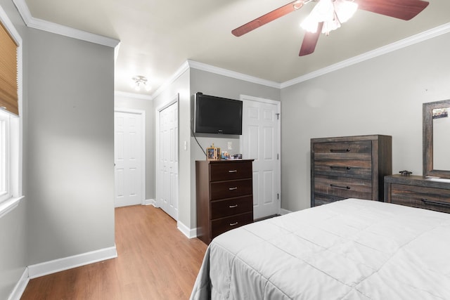 bedroom with crown molding, ceiling fan, and light hardwood / wood-style flooring