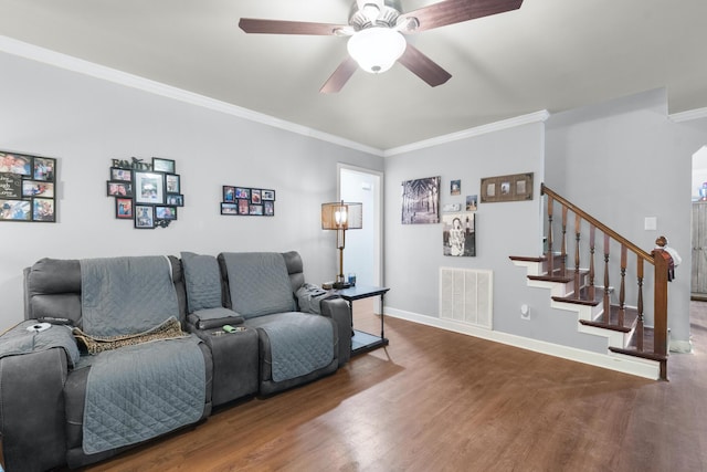 living room with hardwood / wood-style flooring, ornamental molding, and ceiling fan