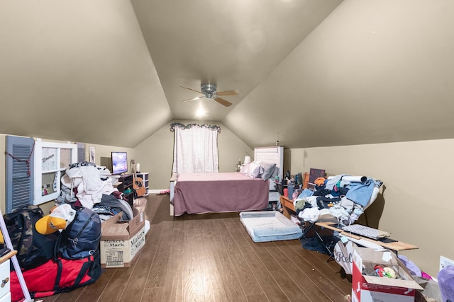 bedroom featuring dark wood-type flooring, vaulted ceiling, and ceiling fan