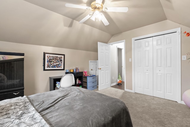 bedroom featuring vaulted ceiling, a closet, ceiling fan, and carpet