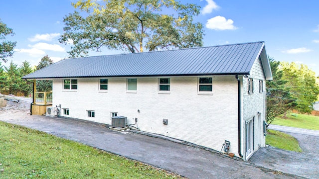 back of property with ac unit and central air condition unit