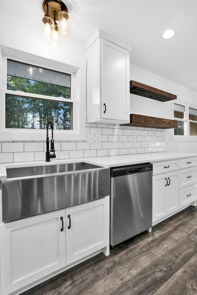 kitchen featuring stainless steel dishwasher, sink, white cabinets, and dark wood-type flooring