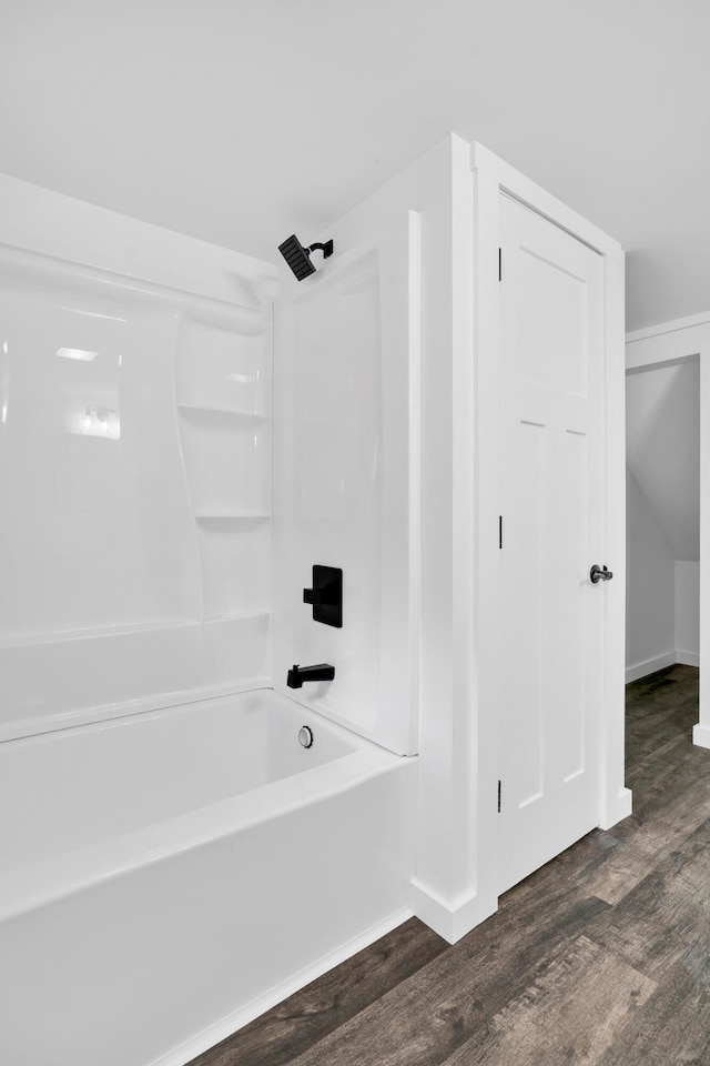 bathroom with hardwood / wood-style floors and tub / shower combination